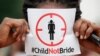 FILE- A woman protests against underage marriage in Lagos, Nigeria, July 20, 2013.