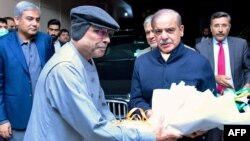 Pakistan's newly sworn-in Prime Minister Shehbaz Sharif, second from right, greets newly elected President Asif Ali Zardari, fourth from right, in Islamabad on March 9, 2024. (Pakistan's Press Information Department via AFP)
