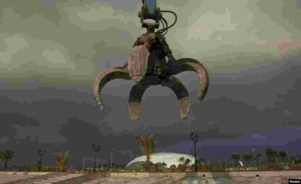 A claw hangs from a crane near venues in the Olympic Park in Adler near Sochi. President Vladimir Putin vowed to annihilate &quot;terrorists&quot; following two deadly bomb attacks in less than 24 hours in the southern Russian city of Volgograd that raised security fears ahead of the Winter Olympics.