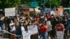 Protesters gather outside of the Queens County Criminal Court, June 8, 2020, in the Queens borough of New York. New York lawmakers are debating police reform bills as protesters demand accountability.