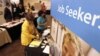 People walk by recruiters at a jobs fair in the Pittsburgh suburb of Green Tree, Pennsylvania, July 10, 2012.