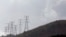 FILE - Electricity pylons snake across a hill in a Johannesburg suburb.