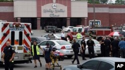 Emergency personnel gather outside the Carmike Hickory 8 movie theater following a shooting in Antioch, near Nashville, Tennessee, August 5, 2015.