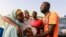 FILE - People react after the arrival of the rescued JSS Jangebe schoolgirls in Jangebe, Zamfara, Nigeria, March 3, 2021.