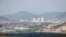 FILE PHOTO: Kaesong city is seen behind the inter-Korean Kaesong Industrial Complex, across the DMZ separating North Korea from South Korea in this picture taken from Dora observatory in Paju