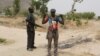 FILE - Members of a civilian vigilante group stand guard at the border with Nigeria in Kerawa, Cameroon, March 16, 2016. 