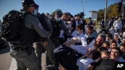 Israeli police officers clash with ultra-Orthodox Jews in Ashdod, Israel, Jan. 24, 2021.
