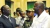 Ivorian President Laurent Gbagbo (R) speaks with Ivorian Defense minister Amani N'guessan (L) in Abidjan, 30 Nov 2009