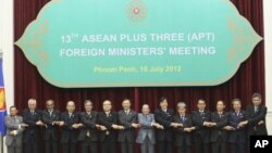 ASEAN countries' foreign ministers join their hands during a photo session at the 45th Association of Southeast Asian Nations (ASEAN) Foreign Ministers' Plus three Meeting in Phnom Penh, Cambodia, Tuesday, July 10, 2012. 