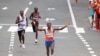 FILE - Abdi Nageeye of the Netherlands crosses the finish line to win silver, with Belgium's Bashir Abdi, left, coming in third and Kenya's Lawrence Cherono placing fourth, in the men's marathon at the 2020 Olympics, in Sapporo, Japan, Aug. 8, 2021. 