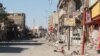 The main street in the Dawasa neighborhood of western Mosul was a hub for restaurants and nightlife more than a decade ago. Now the shops are burnt out or destroyed and the area is abandoned, March 10, 2017. (H. Murdock/VOA)