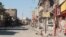 The main street in the Dawasa neighborhood of western Mosul was a hub for restaurants and nightlife more than a decade ago. Now the shops are burnt out or destroyed and the area is abandoned, March 10, 2017. (H. Murdock/VOA)