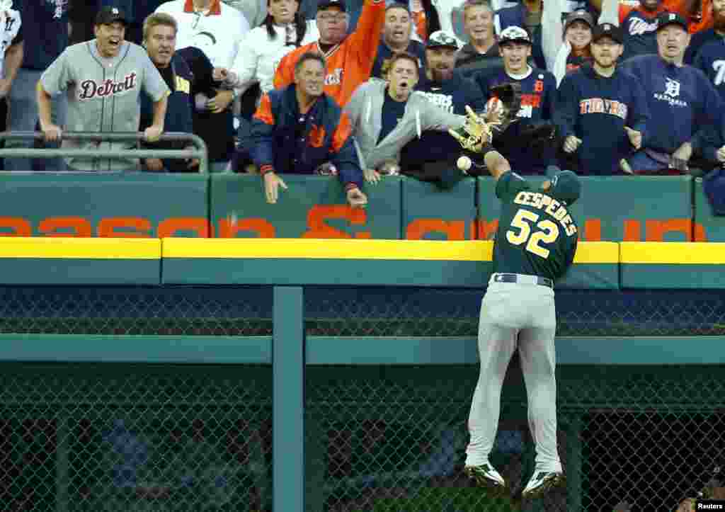 Oct 8, 2013; Detroit, MI, USA; Oakland Athletics outfielder Yoenis Cespedes (52) is unable to catch a ball hit for a three-run home run by Detroit Tigers outfielder Jhonny Peralta (not pictured) in game four of the American League divisional series playoff baseball game at Comerica Park, Detroit, Michigan, USA. (Credit: Rick Osentoski/ USA TODAY Sports)
