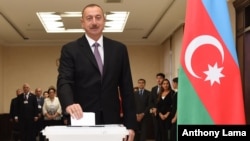 Azerbaijani President Ilham Aliyev casts his ballot at a polling station during a referendum in Baku, Azerbaijan, Sept. 26, 2016. 