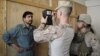 U.S. marines of Fox Co, 2nd Battalion, 7th Marines Regiment get a biometric scan of an Afghan local police trainee before the start of a basic police course training at Combat Outpost Musa Qal-Ah in Helmand province, October 31, 2012.