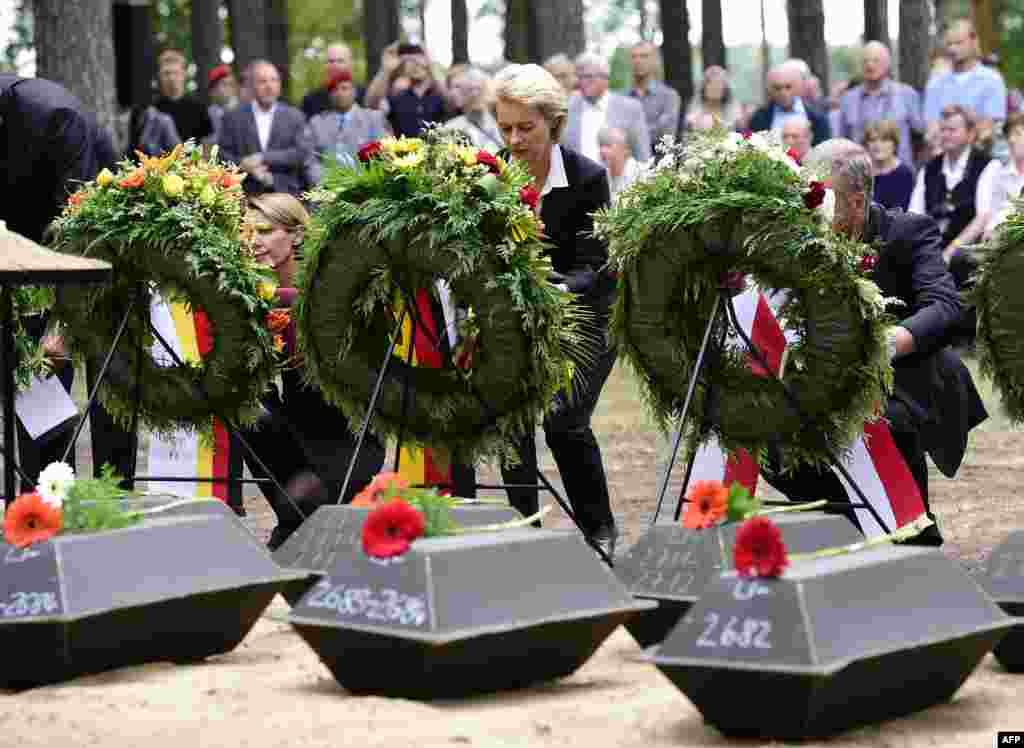 German Defense Minister Ursula von der Leyen (C) attends the burial of the remains of 71 German soldiers who died in World War II during a commemoration ceremony organized by the German War Graves Commission in Halbe, eastern Germany.