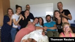 FILE - Amanda Eller, a yoga instructor who went missing for 17 days while hiking in Maui's Makawao Forest Reserve, poses for a photo from her hospital bed at Maui Memorial Medical Center in Hawaii.