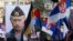 FILE - A supporter of Serbian ultranationalist leader Vojislav Seselj holds a picture of Russian President Vladimir Putin during a protest In Belgrade, Serbia. 