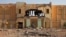 A man walks past the destroyed former customs building, which was used as a base by radical Islamists, in Gao, Mali, February 28, 2013.