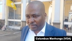 Charles Kwaramba, of the group Zimbabwe Lawyers for Human Rights, speaks to reporters outside Harare Magistrates Court, Sept. 4, 2024.