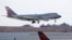 FILE - A China Airlines cargo jet lands at John F. Kennedy International Airport, March 14, 2020, in New York. 