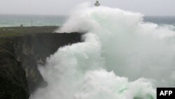Large waves created by Typhoon Vongfong crash into a cliff wall along the coast of Okinawa, Oct. 13, 2014. 