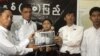 Burma's prominent student leader, Min Ko Naing, second from right, senior leader, Ko Ko Gyi, left, and other members hold a picture of recently detained student activists in Rangoon, Burma, July. 7, 2012.