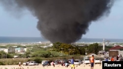 Dark smoke rises above Aden Abdule International Airport in Somalia's capital Mogadishu, Aug. 9, 2013.