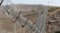 FILE - A view of the border fence outside the Kitton outpost on the border with Afghanistan in North Waziristan, Pakistan, Oct. 18, 2017.