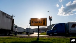 FILE - Semitrucks head to the truck parking lot at the Love's Travel Stop truck stop in Greenville, Va. During the coronavirus outbreak truckers continue to work so the supply chain is not disrupted.