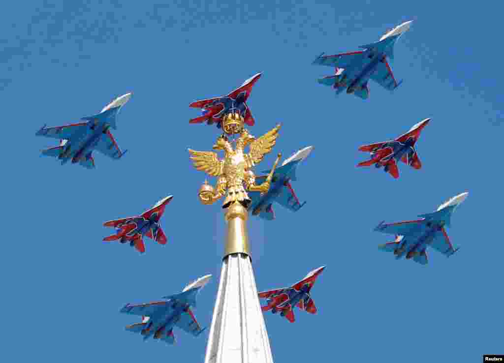 Russian army MiG-29 fighter jets of the Strizhi (Swifts) and Su-30 fighter jets of the Russkiye Vityazi (Russian Knights) aerobatic teams fly in formation during the Victory Day parade, marking the 73rd anniversary of the victory over Nazi Germany in World War II, in central Moscow.