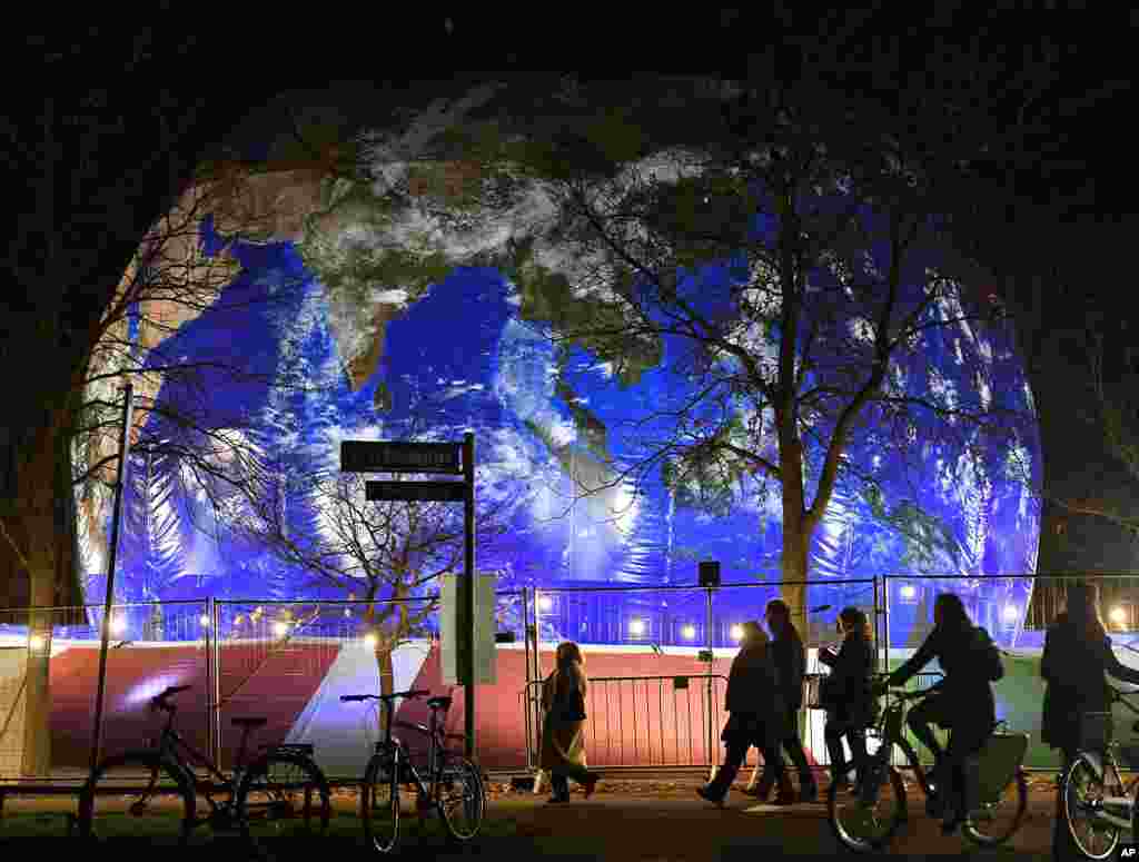 People pass the German pavilion, created to represent Earth, during the COP 23 Fiji U.N. Climate Change Conference in Bonn, Germany.