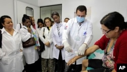A group of Cuban doctors attend a training session at a health clinic in a low-income neighborhood in Brasilia, Brazil, Friday, Aug. 30, 2013.