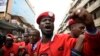 FILE - Musician turned politician Robert Kyagulanyi, aka Bobi Wine, is joined by other activists in Kampala, July 11, 2018. Kyagulanyi was among the opposition legislators who were arrested Monday, then reportedly tortured by security forces.