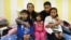 FILE - Jeanette Vizguerra (2-L) poses with her husband Salvador Baez (2n-R) and their children in the First Unitarian Society Church of Denver, in Denver, Colorado, Feb. 16, 2017. The family, undocumented immigrants, had taken refuge in the church for fear of being deported by Immigration and Customs Enforcement.