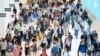 FILE - FILE - In this June 21, 2019, file photo commuters walk through a corridor in the World Trade Center Transportation Hub in New York. 