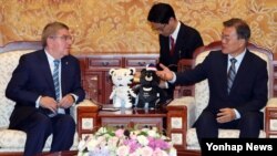 문재인 한국 대통령(오른쪽)이 지난 7월 청와대에서 토마스 바흐 국제올림픽위원회(IOC) 위원장을 만나 대화하고 있다.