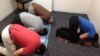 US Muslim Rizwan Jaka (in gray shirt) prays with fellow employees at his workplace. (Photo by Shad Imam) 
