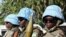 The blue helmets of UN peacekeepers distinguish them from the many armed groups in Darfur