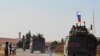 A convoy of Russian military vehicles heads for the Syrian city of Kobane, Oct. 23, 2019. Russian forces in Syria headed for the border with Turkey to ensure Kurdish fighters pull back after a Moscow-Ankara deal wrested control of the Kurds' heartland.