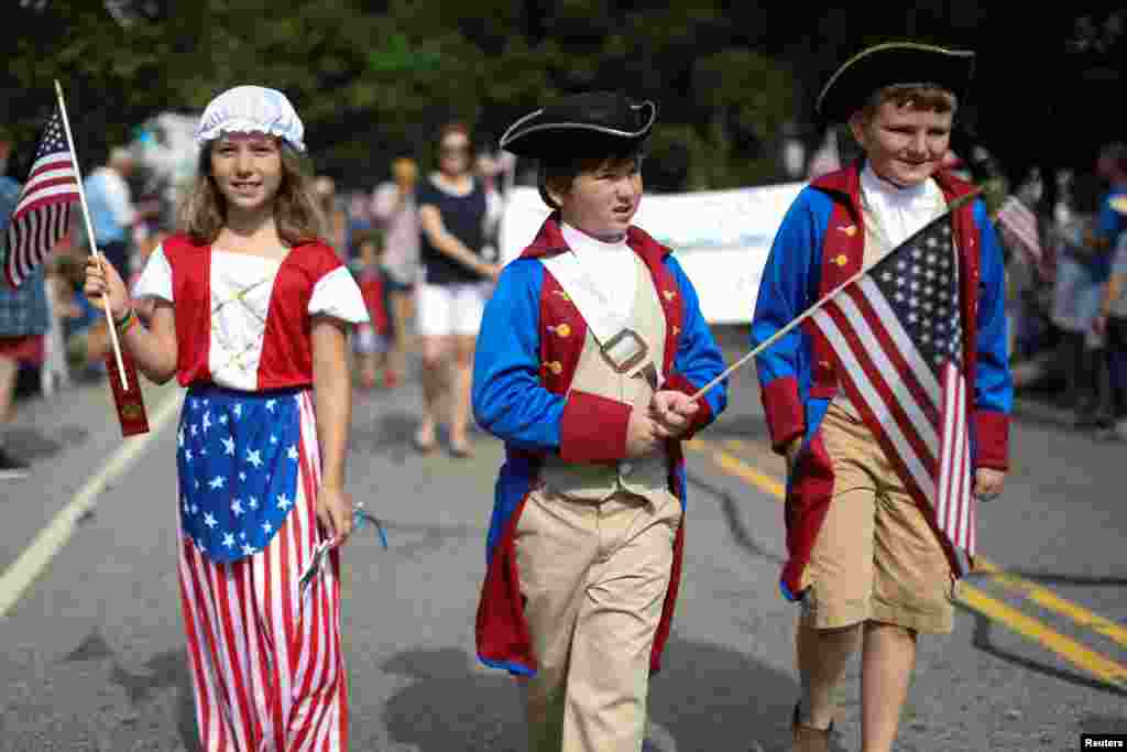 Children in costumes march down Main Street during the annual Fourth of July parade in Barnstable Village in Cape Cod, Massachusetts.