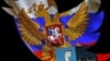 FILE - A Russian flag and a 3-D model of the Facebook logo are seen through a cutout of the Twitter logo in this photo illustration taken in Zenica, Bosnia and Herzegovina, May 22, 2015.