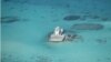 FILE - In this photo taken Feb. 28, 2013 by a surveillance plane, and released on May 15, 2014, by the Philippine Department of Foreign Affairs, Chinese-made structures stands on the Johnson Reef, called Mabini by the Philippines and Chigua by China, in the Spratly Islands in South China Sea.