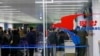 Passengers wearing masks as a precaution against a new coronavirus line up to check in for a flight to Vladivostok, Russia, at the Pyongyang International Airport in Pyongyang, North Korea, Monday, March 9, 2020.