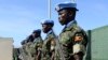 FILE - Ugandan peacekeeping troops stand during a ceremony at Mogadishu airport in Somalia, May 18, 2014. 