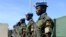 FILE - Ugandan peacekeeping troops stand during a ceremony at Mogadishu airport in Somalia, May 18, 2014. 