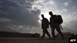 Dua marinir Amerika Serikat berjalan di Kamp Hansen, di Marjah, Provinsi Helman, Afghanistan, 4 Mei 2011. (Foto: AFP)
