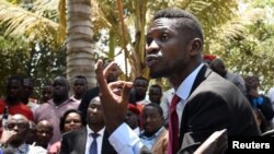 FILE - Ugandan musician-turned-politician Robert Kyagulanyi, also known as Bobi Wine, holds a news conference at his home near Kampala, Sept. 24, 2018. 