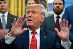 FILE - President Donald Trump speaks to reporters in the Oval Office at the White House, Feb. 11, 2020, in Washington.