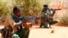 FILE - Kenyan policemen hold their position while patrolling the Kenya-Somalia border near the town of Mandera. A string of attacks earlier this month have raised safety concerns about in the Mandera region.